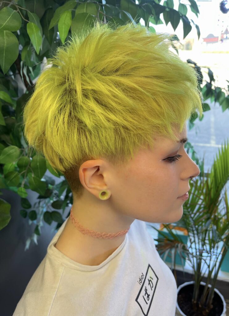 Green textured short pixie haircut with natural movement